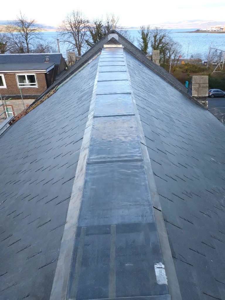 Lead-dressed ridge on a roof with the sea in the distance